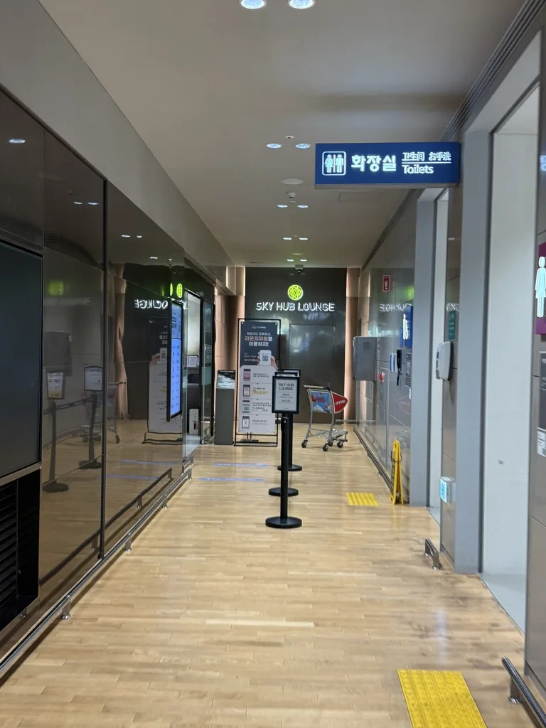 SkyHub Lounge entrance corridor with neon sign