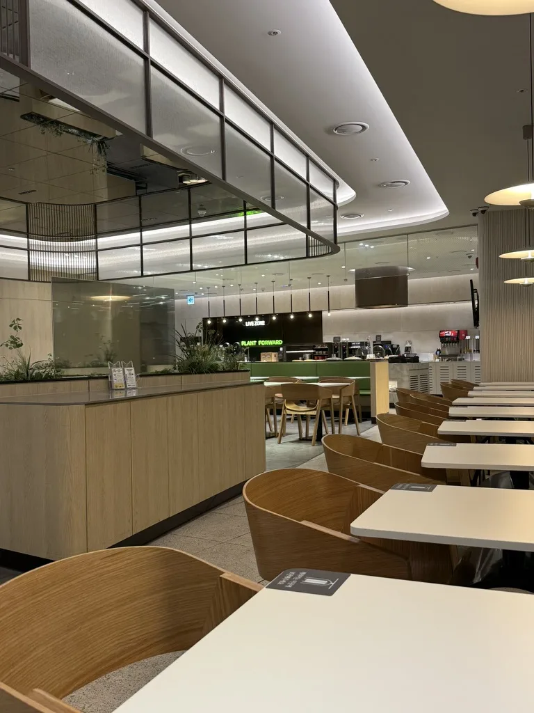 SkyHub Lounge interior with Live Zone and Plant Forward sections