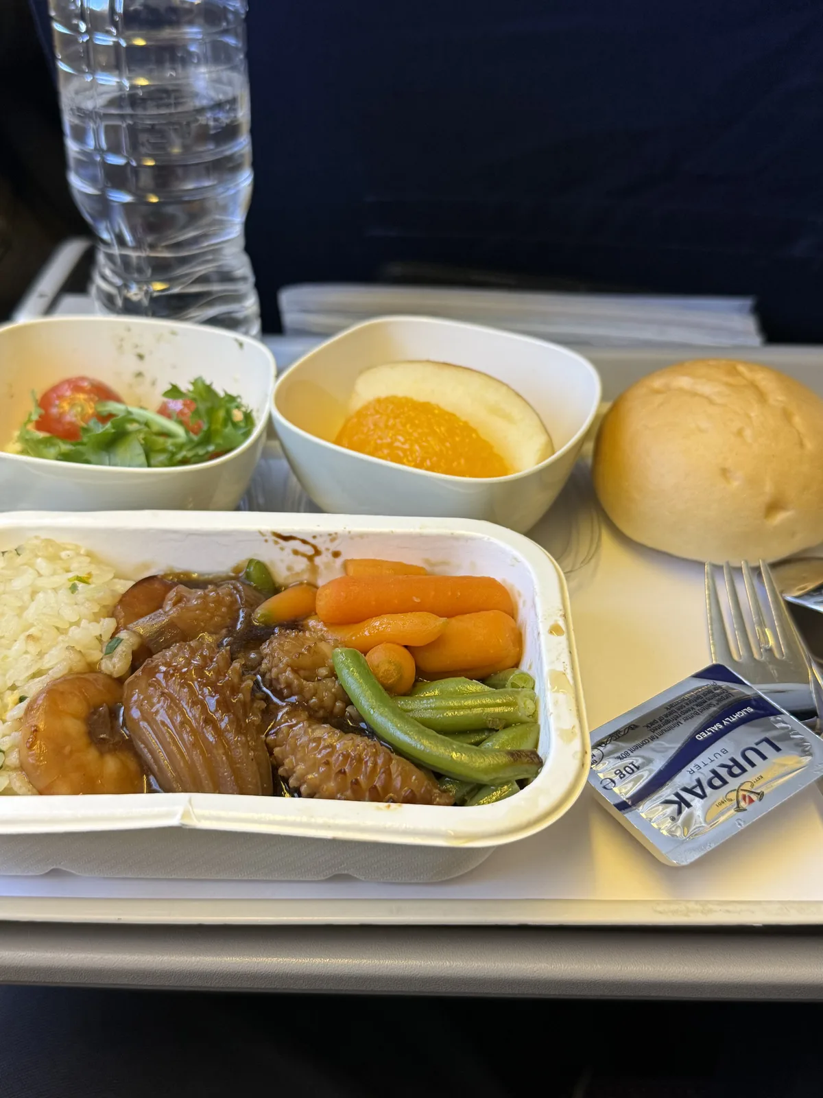 Korean Air economy class meal on GMP–HND route with main dish and dinner roll