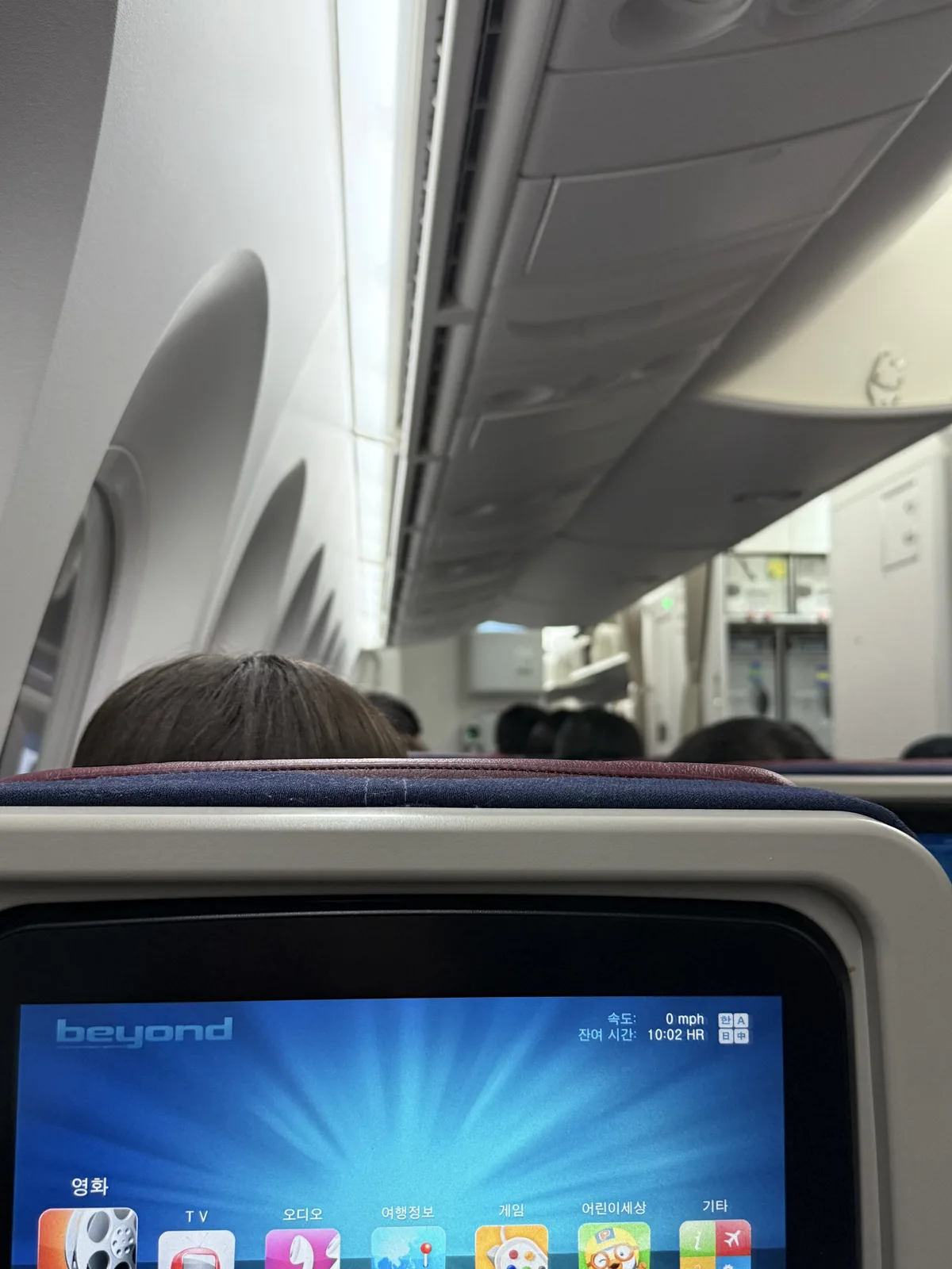 Korean Air economy class seat on B787-9 showing legroom and power outlet
