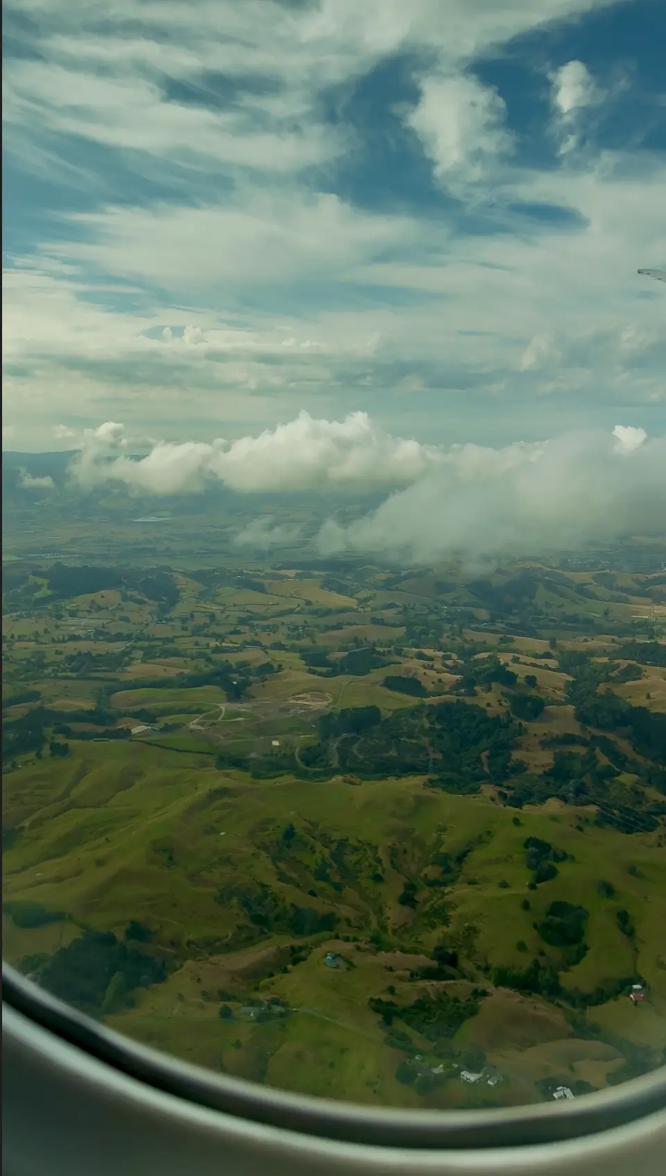 Aerial view of New Zealand landscape at sunrise during approach to Auckland
