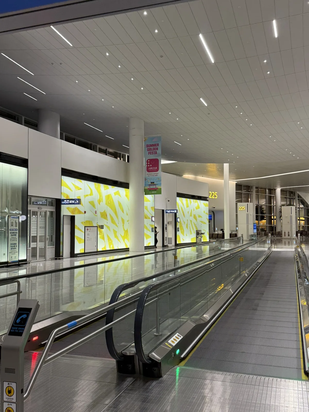 Late-night corridor near Gate 225 area at Terminal 2