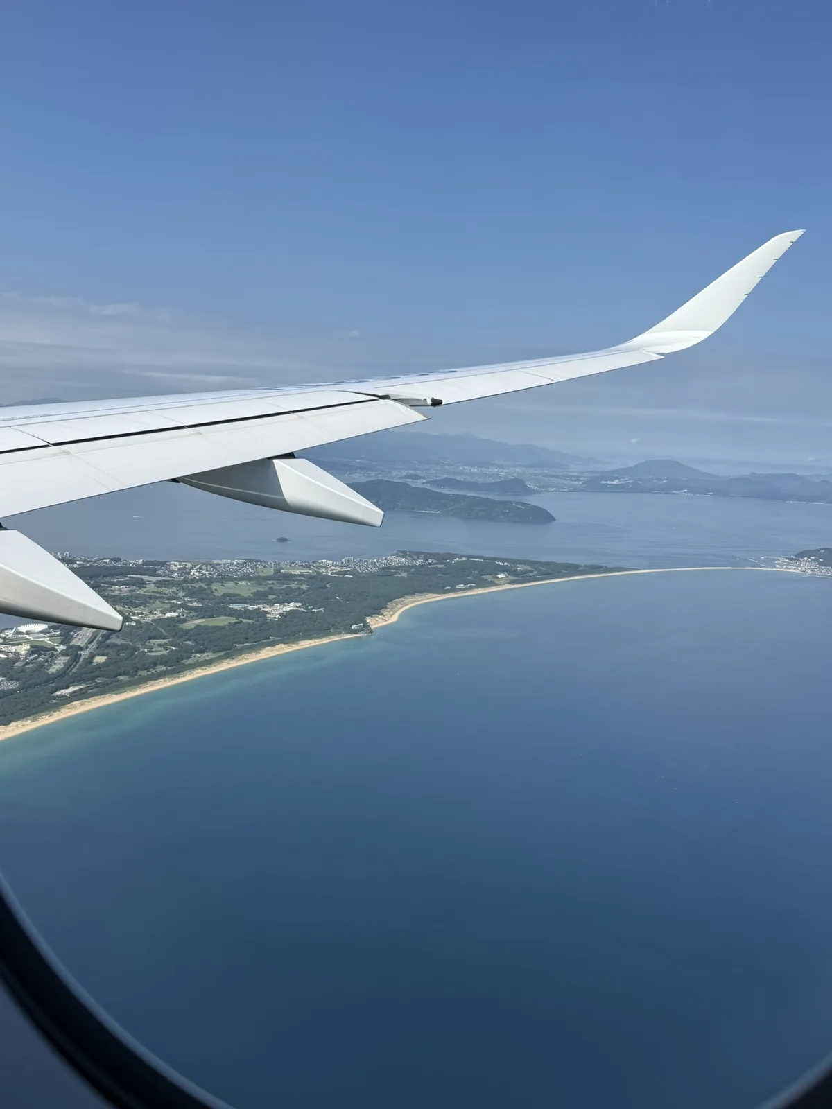 Approaching Fukuoka: Hakata Bay coastline and wing from the window