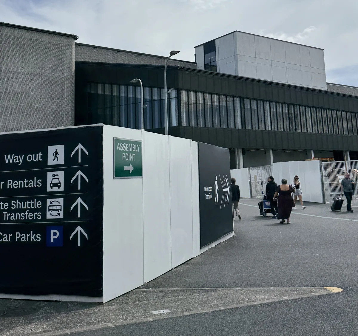 Green line markings on floor guiding passengers to inter-terminal shuttle bus at Auckland Airport