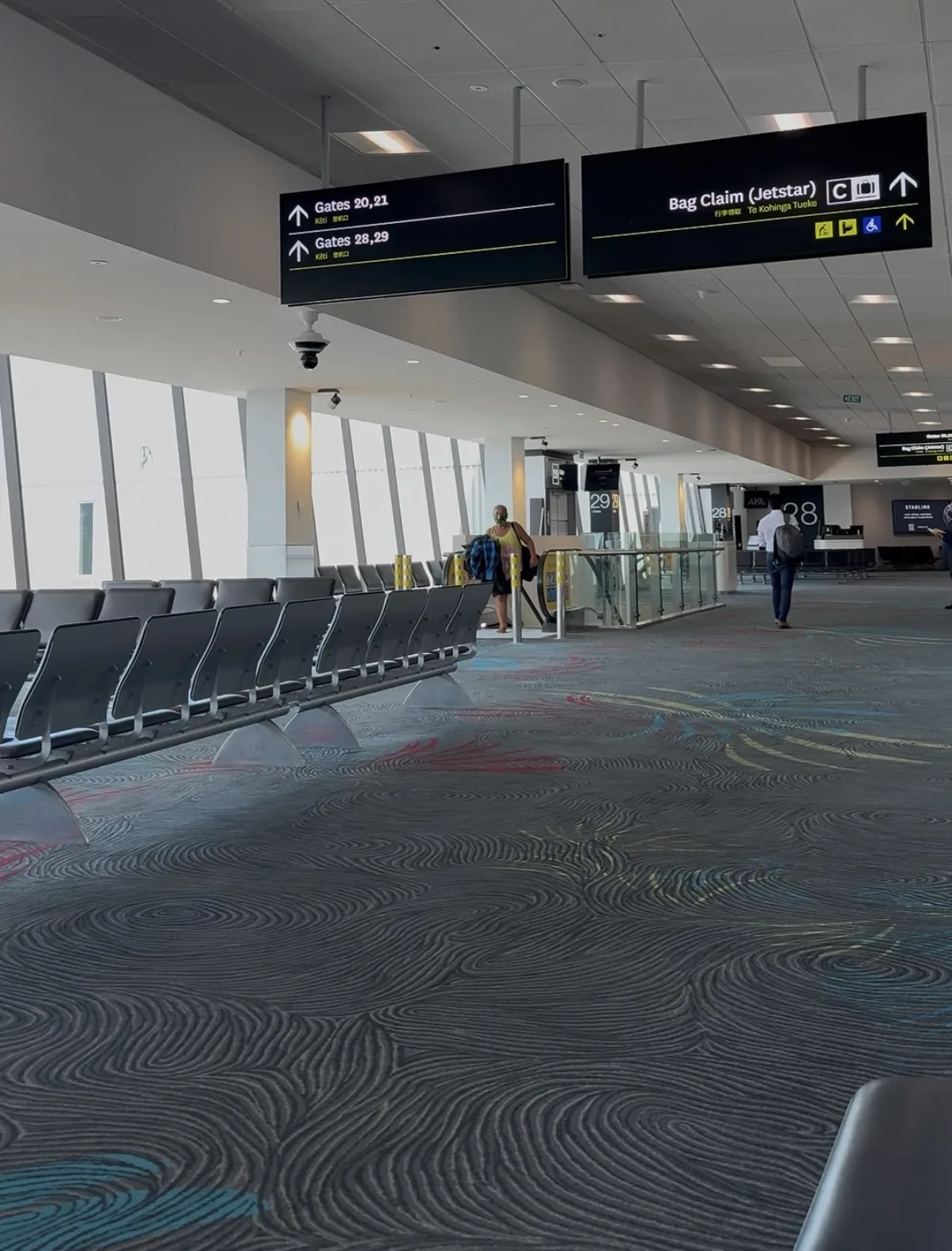 Auckland Airport domestic terminal departure area with Maori language signage