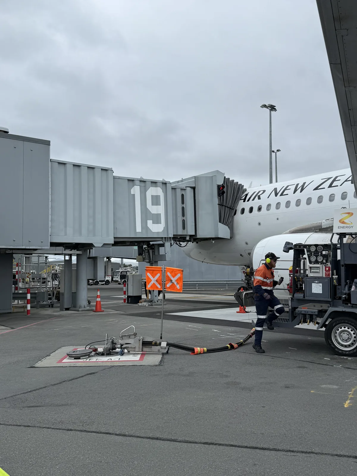Air New Zealand A320 being refueled on the tarmac at Christchurch Airport after landing