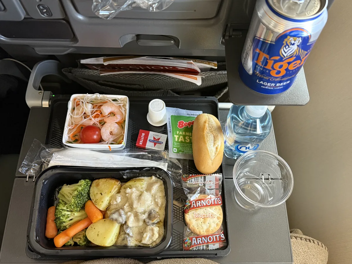 Singapore Airlines economy class meal tray with main dish and Tiger Beer