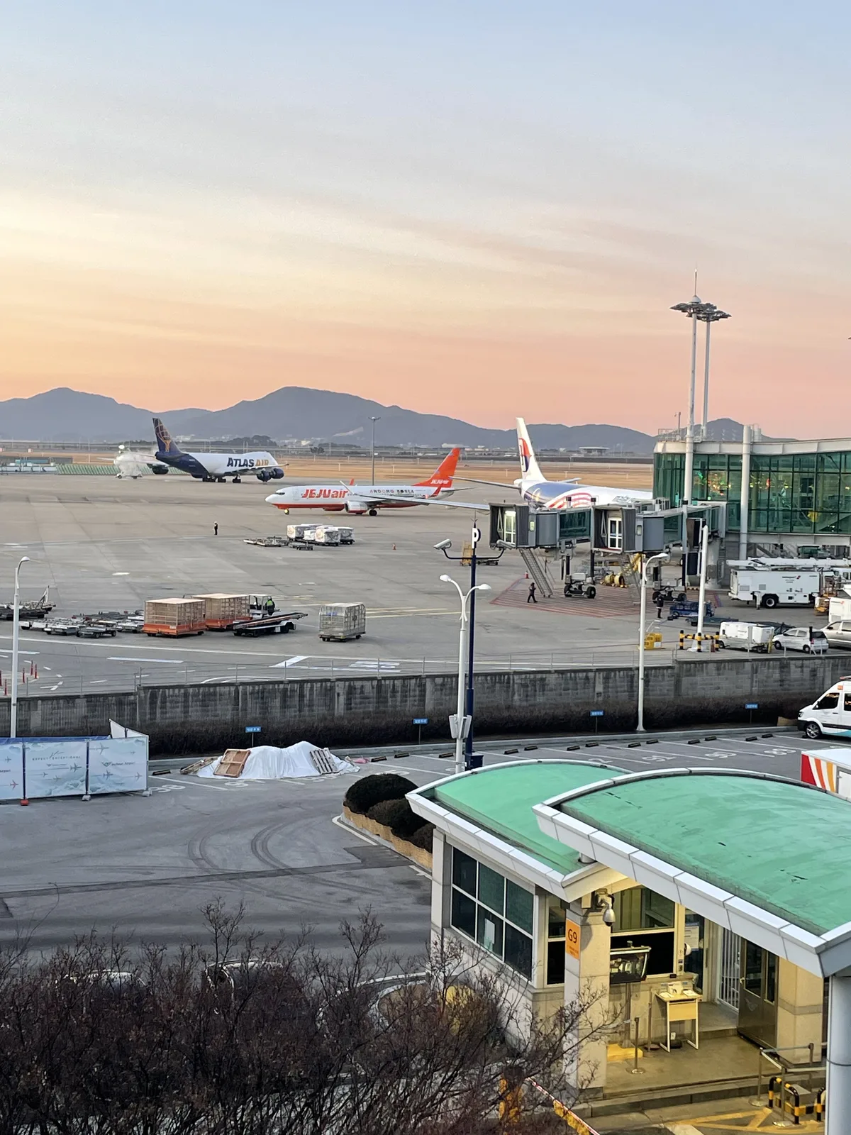 Aircraft on the apron viewed from Incheon Airport terminal windows in below-freezing weather