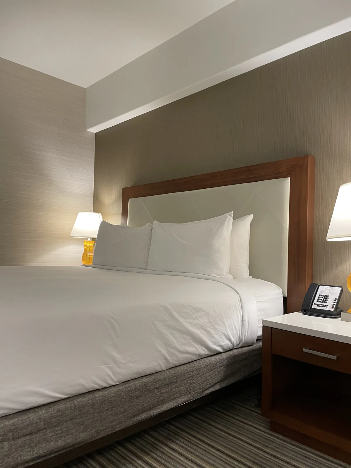 Crowne Plaza Seattle King Room headboard close-up showing clean wood frame with white bedding