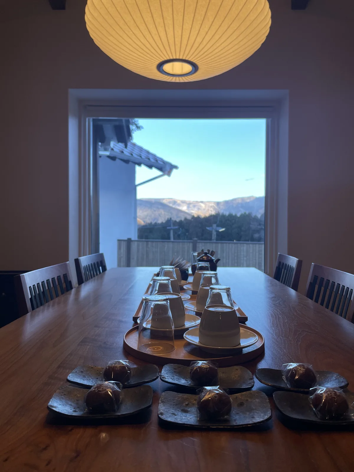 View of Yufuin greenery and garden from the villa dining table window