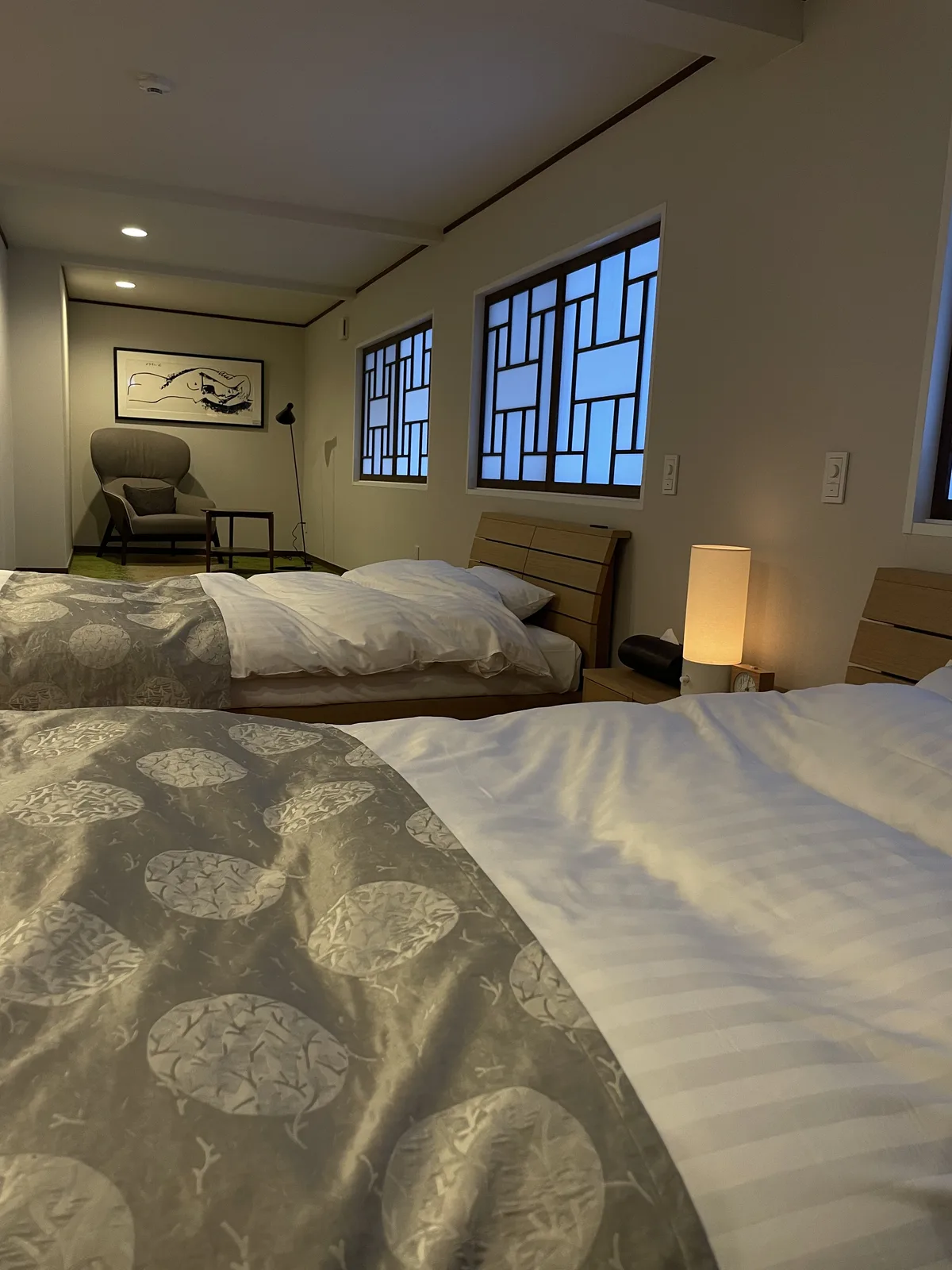 Second floor bedroom in Ikkouten villa with two beds and mezzanine level above