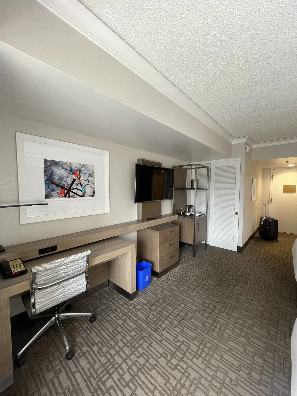 Hilton Seattle room showing desk, TV, and wardrobe lined along one wall