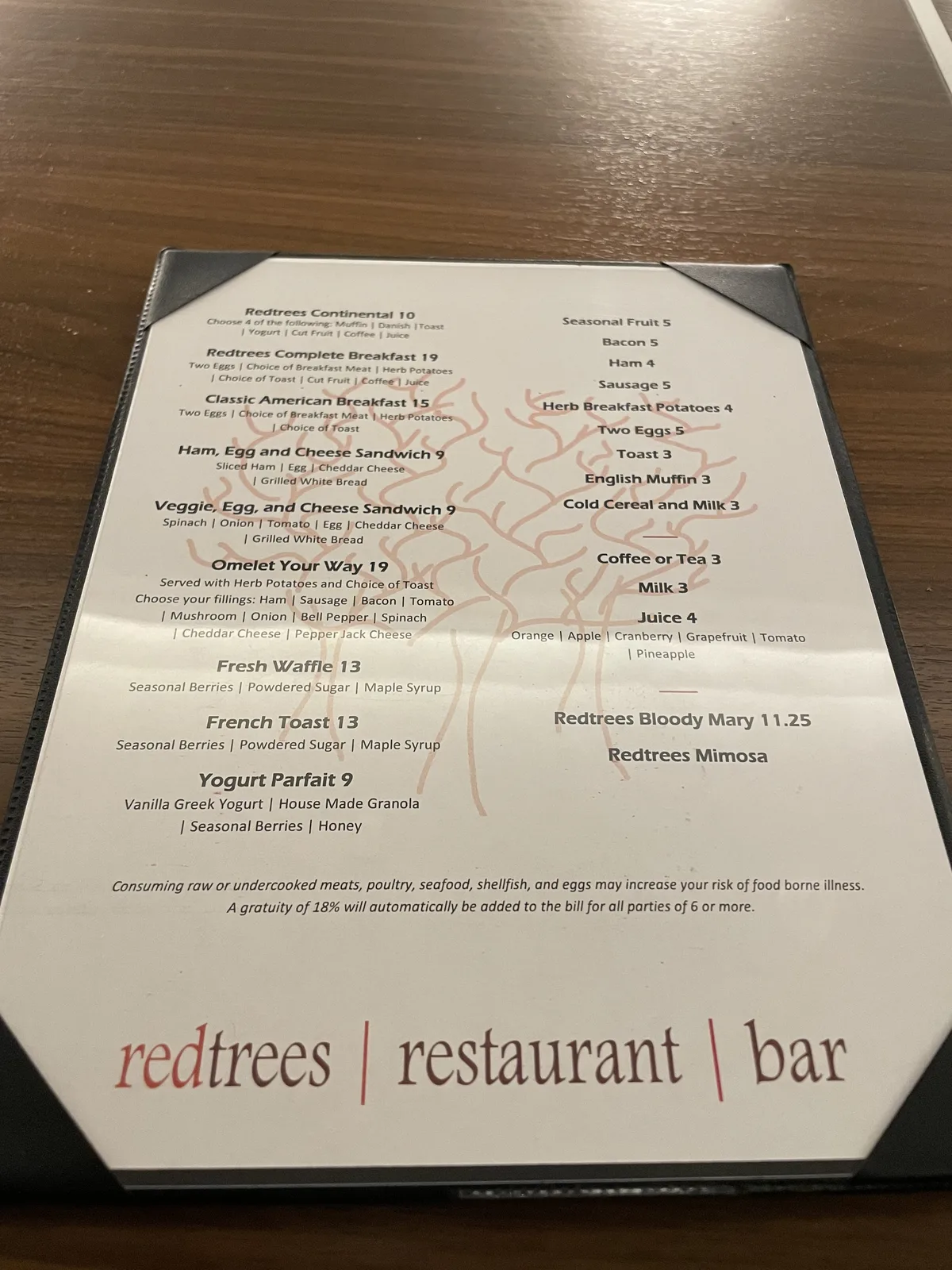 Hilton Seattle Redtrees restaurant breakfast menu displayed at the restaurant entrance