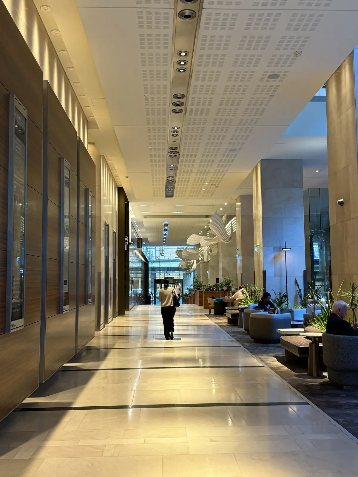 Hilton Sydney lobby interior showing elongated corridor with seating area