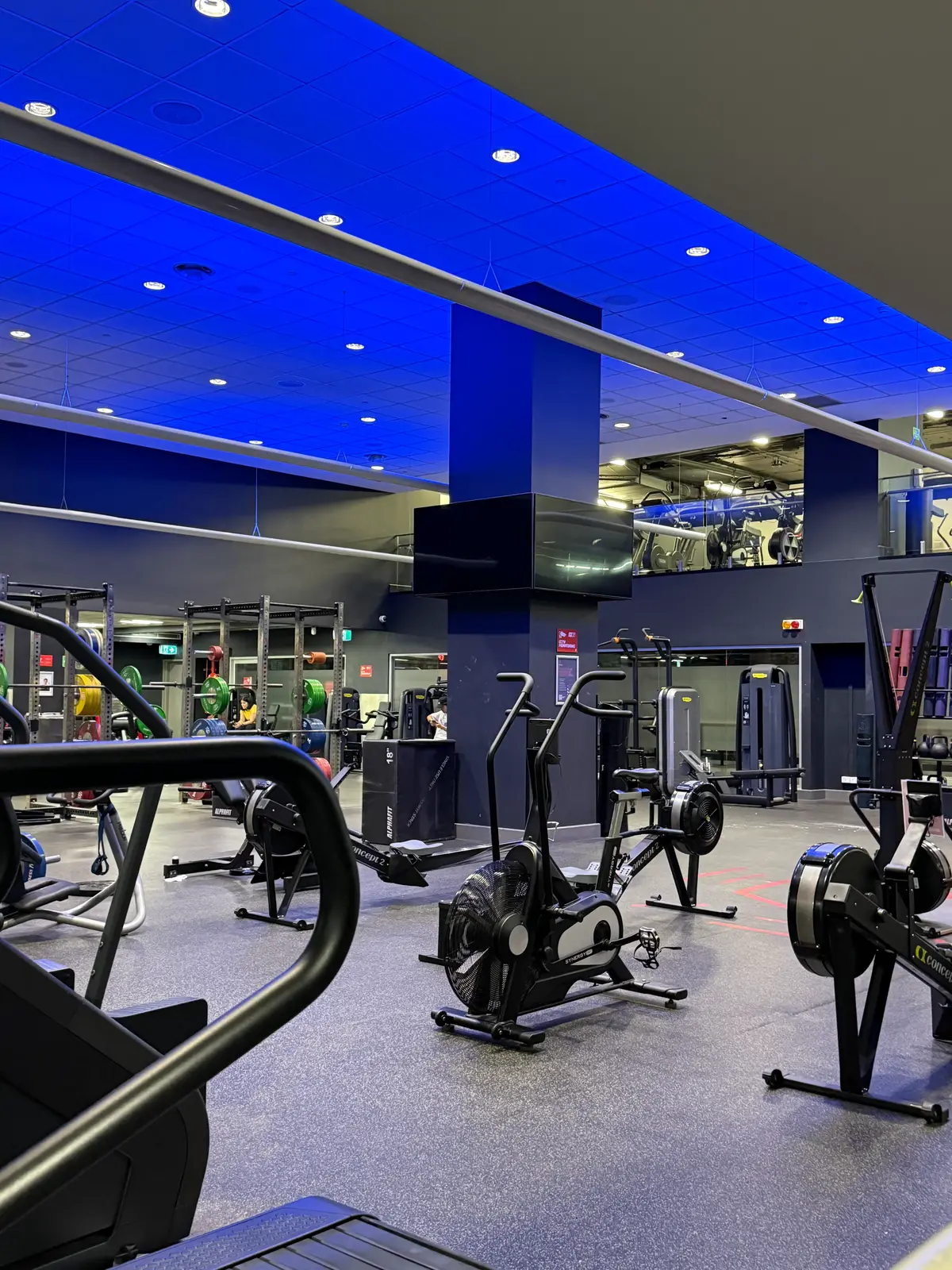 Hilton Sydney gym with extensive equipment and double-height ceiling