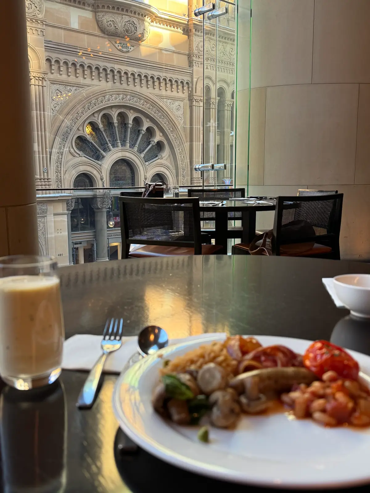 Hilton Sydney breakfast dining room with floor-to-ceiling windows overlooking Queen Victoria Building