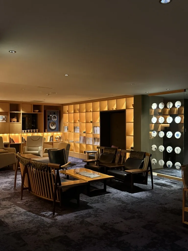 Kuriya Suizan lounge with illuminated ceramic plate display and wood furniture
