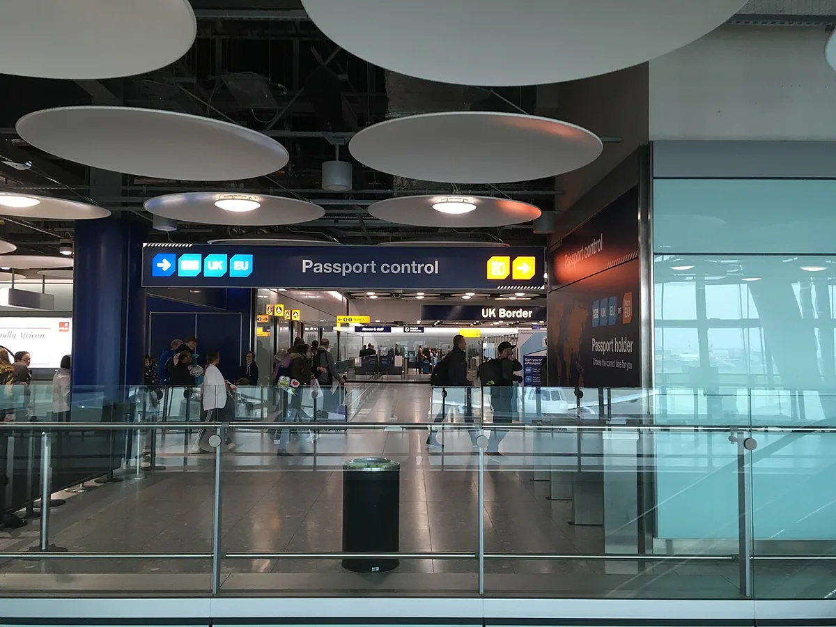 Passport control and UK Border signs in a British airport arrivals hall