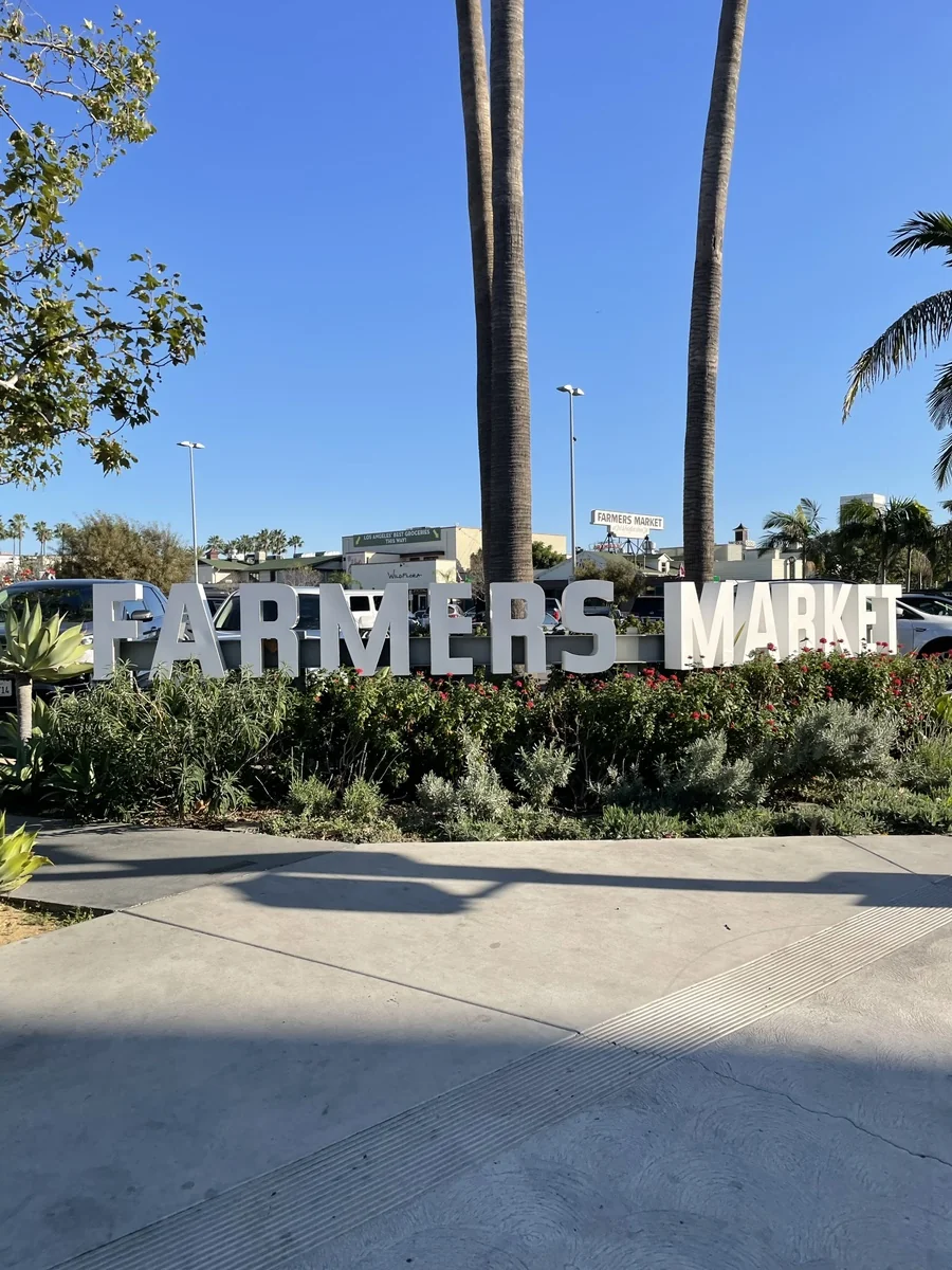 야자수 아래 큼직하게 세워진 FARMERS MARKET 입구 조형물